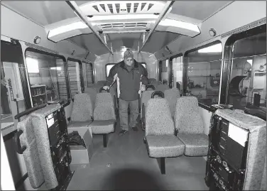  ?? NWA Democrat-Gazette/FLIP PUTTHOFF ?? John Williams, transit coordinato­r at Ozark Regional Transit, inspects Saturday a new bus delivered in Springdale. The bus was driven to the transit service from the factory in Indiana.