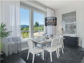 ??  ?? This show suite dining room is from a Morningsta­r Homes neighbourh­ood on Burke Mountain. Where plans permit, spaces at Pacific Heights will offer a similar design, with large windows and custom window seats.