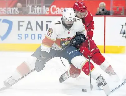  ?? SANCYA/AP
PAUL ?? Panthers defenseman Radko Gudas (7) defends Red Wings center Sam Gagner during the second period of Friday’s game in Detroit.