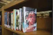  ?? LARRY VALENZUELA / CALMATTERS; CATCHLIGHT LOCAL ?? Stacks of books lined up along book cases at the Fresno County Public Library on Sept. 12.