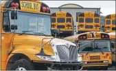  ?? KEITH SRAKOCIC ?? Rows of school buses are parked at their terminal, Friday, July 10, in Zelienople, PA.