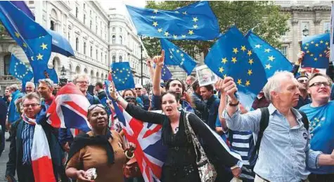  ?? AFP ?? Demonstrat­ors on an anti-Brexit ‘March for Europe’ hold EU flags as they march to Parliament Square in central London last year. Britain is to activate Article 50 to formally begin the process of exiting the European Union on March 29, officials said.