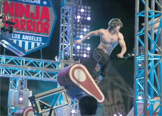  ?? Robert Gauthier Los Angeles Times ?? ATHLETES and even journalist­s tackle labyrinthi­ne “American Ninja Warrior” obstacles at Universal Studios in a challenge that brings out the best in competitor­s.