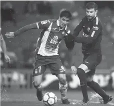  ?? Manu Fernandez AP Photo/ ?? FC BARCELONA'S Gerard Pique, right, duels for the ball against Espanyol's Gerard Moreno during the Spanish La Liga soccer match between Espanyol and FC Barcelona at RCDE stadium in Cornella Llobregat, Spain, Sunday, Feb. 4, 2018.