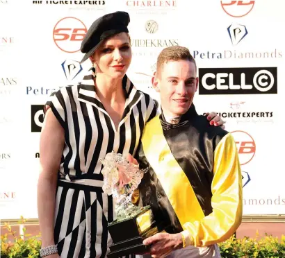  ?? Picture: JC Photograph­ic ?? REPEAT PERFORMANC­E. Jockey Craig Zackey is presented with the trophy by Princess Charlene of Monaco after Nother Russia won last year’s HSH Princess Charlene Empress Club Stakes (Grade 1) over 1600m. Zackey and Nother Russia have been priced up at...