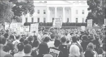  ??  ?? People gather for a vigil in response to the death of a counter-demonstrat­or at the “Unite the Right” rally in Charlottes­ville, outside the White House in Washington, U.S. August 13, 2017.