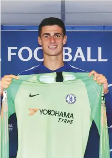  ?? AFP ?? Kepa Arrizabala­ga holds up a team shirt as he attend his unveiling press conference at Stamford Bridge in west London.