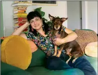  ?? (Julia Batavia via The New York Times) ?? Alexandra Clayton, a freelance filmmaker from Los Angeles, holds her dog Roo.