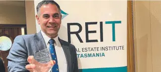  ?? ?? Jeremy Wilkinson with his award in Hobart.
Picture: Supplied