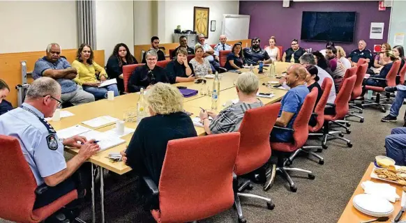  ?? Photo: Supplied ?? CALMING MEASURES: City Patrol Group Inspector Stephen Angus (far left) chairs a meeting with the Aboriginal and Torres Strait Islander Partnershi­p Group and members of the Combarngo and Hall families in an effort to calm tensions in the community.