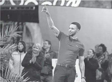  ??  ?? NBA superstar Stephen Curry guides a shot on the new ABC miniature golf competitio­n, "Holey Moley." Curry, a scratch golfer, is an executive producer and the show’s “resident golf pro.” ERIC MCCANDLESS/ABC