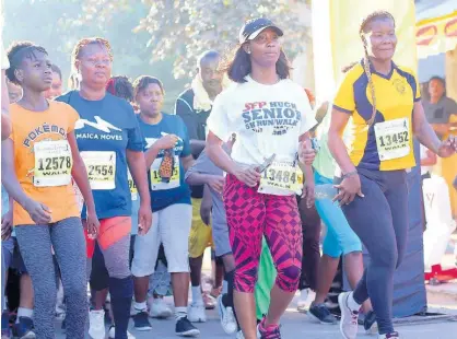  ?? FILE ?? Sprinting star Shelly-Ann Farser-Pryce (second right) gets going at the start of the inaugural SFP/Hugh Senior 5k Run/Walk in 2018 in Waterhouse, St Andrew.