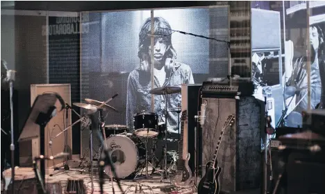  ?? JOEL RYAN/ INVISION/ THE ASSOCIATED PRESS ?? An image of Mick Jagger forms the backdrop of a recreated music studio where the “Greatest Rock ‘n’ Roll Band in the World” recorded. It’s part of Exhibition­ism, a multimedia exhibit of the Rolling Stones’ career at the Saatchi gallery in London.