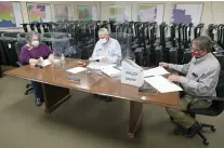  ?? The Sentinel-Record/Richard Rasmussen ?? Q LEFT: Garland County election commission­ers Kay Ekey, left, Gene Haley and Ralph Edds work on drawing ballot positions Friday for the May 18 annual school elections.