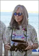  ?? ?? Wendall DeVera, Vietnam veteran, longtime paddler and president of Pu‘ali Koa Kahiko, listens to opening speeches and a blessing of a Hawaiian outrigger canoe on Friday morning in South Maui.