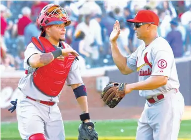  ?? | AP ?? Cardinals catcher Yadier Molina (with teammate Carlos Beltran this season at Wrigley Field) is a great example of a behind-the-plate leader.