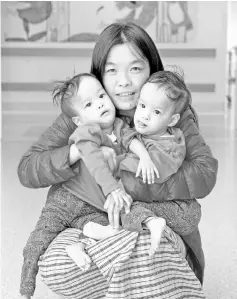  ??  ?? File photo shows Dawa (left) and Nima with their mother at the hospital in Melbourne. — AFP photo