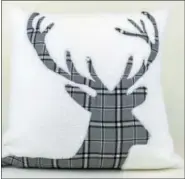  ?? MACY’S VIA AP ?? A holiday pillow from the Martha Stewart Collection at Macy’s. The cozy sherpa fleece throw pillow is appliquéd with a plaid stag’s head.