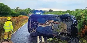  ?? REX/PA ?? Lost control: Price’s BMW lies on its side across a country lane after crash close to her home