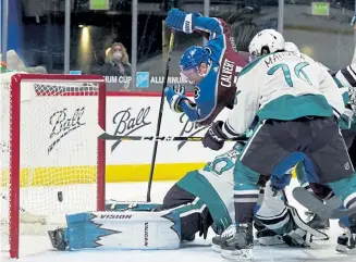  ?? David Zalubowski, The Associated Press ?? Avalanche left wing Matt Calvert, center, has his redirected shot stopped by Anaheim goaltender Ryan Miller, left, as defenseman Josh Mahura covers on Tuesday.