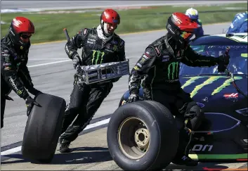  ??  ?? Kurt Busch’s crew changes tires during a pit stop in the 1000Bulbs.com 500 NASCAR Cup Series auto race at Talladega Superspeed­way, on Sunday, in Talladega, Ala. AP PHOTO/BUTCH DILL