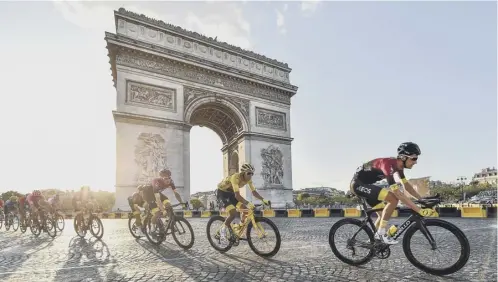  ??  ?? 0 Last year’s winner Egan Bernal of Team Ineos in the yellow jersey as he passes the Arc de Triomphe on the final stage into Paris.