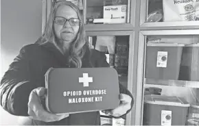  ?? ANDREW SELSKY/AP ?? Debra Cross, director of operations for Provoking Hope, an addiction recovery center in Mcminnvill­e, Ore., displays an emergency kit used to treat opioid overdose as she stands inside a mobile needle-exchange unit.