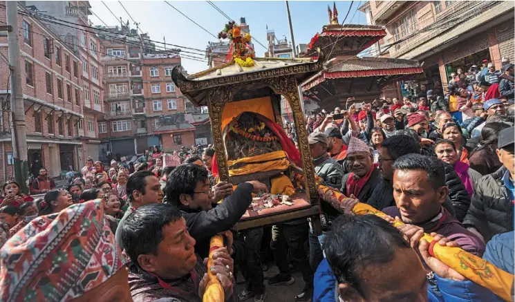  ?? Nepal. — AP ?? A 16th century statue of Hindu deity Uma-maheswora, that was stolen four decades ago and later repatriate­d, is paraded in a chariot before reinstatin­g the same at the premises of a temple where it belonged in Lalitpur,