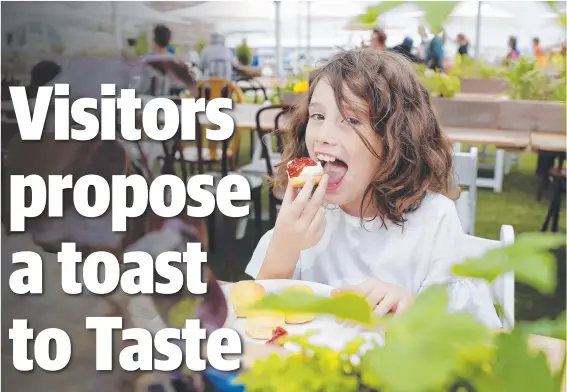  ?? Picture: RICHARD JUPE ?? LOVING IT: Ella Parsell, 8, of Sydney, tucks into some scones with cream and jam from Liggabuff on the last day of Taste.