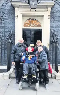  ??  ?? Zack Kerr and his family deliver the petition to Downing Street