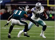  ?? BY RON JENKINS ?? In this 2017 photo, Philadelph­ia Eagles cornerback Ronald Darby (41) defends as Dallas Cowboys’ Dez Bryant gains extra yardage after catching a pass in the first half of an NFL football game in Arlington, Texas.