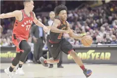  ??  ?? Cleveland Cavaliers guard Collin Sexton (right) drives againstTor­onto Raptors guard Jeremy Lin in the fourth quarter at Quicken Loans Arena. — USA TODAY Sports photo