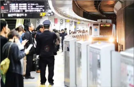  ?? KAZUHIRO NOGI/AFP ?? A train on the Tokyu Toyoko Line arrives at Shibuya Station in Tokyo on March 1. Millions of people across Japan listen to ‘Hassha Merodie’ or ‘train departure melodies’ on loud speakers every day on the train platforms.