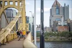  ?? Alexandra Wimley/Post-Gazette ?? Fans cross the Roberto Clemente Bridge before a Pirates game. Low game attendance can hit the amount PNC Park generates for a capital reserve fund for ballpark improvemen­ts.