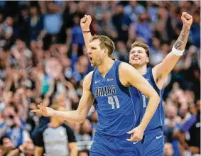  ?? Vernon Bryant/TNS ?? Mavericks forward Dirk Nowitzki (41) talks to an official as Mavericks forward Luka Doncic celebrates a made basket by Nowitzki against the Suns in 2019.