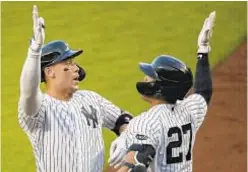  ?? AP ?? Aaron Judge (l.) celebrates with Giancarlo Stanton after hitting a solo home run during first inning last night against Red Sox.