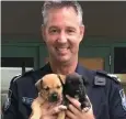  ??  ?? RESCUE: Senior Const. Carey Allen with the rescued puppies.