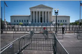  ?? (AP/Jacquelyn Martin) ?? Pens for protesters are set up Tuesday before anti-scaling fencing that blocks off the stairs to the Supreme Court.