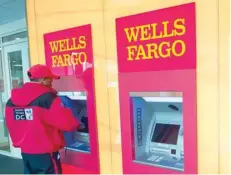  ?? — Reuters ?? A man uses an ATM machine at Wells Fargo bank in Washington, DC.