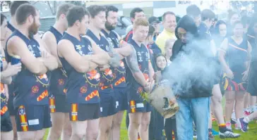  ??  ?? Local elder Trevor Mullett conducts the smoking ceremony for Longwarry players during the club’s indigenous round match against Nilma-Darnum earlier this season.