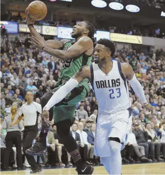  ??  ?? RISING TO OCCASION: Jae Crowder goes past the Mavericks’ Wesley Matthews for a layup during the Celtics’ 111-98 victory last night in Dallas.