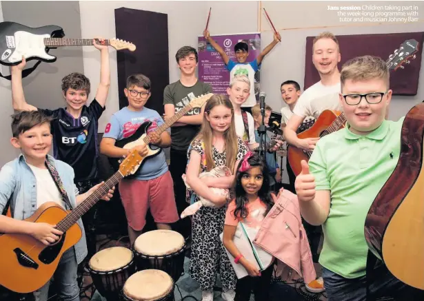  ??  ?? Jam session Children taking part in the week-long programme with tutor and musician Johnny Barr