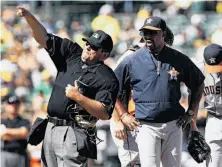  ?? Tony Avelar / Associated Press ?? Hunter Wendelsted­t tosses Houston manager Bo Porter in the fifth. It was Porter’s second ejection of the series.