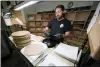  ?? MARK HUMPHREY - THE ASSOCIATED
PRESS ?? Ricky Riehl inspects finished vinyl records for physical flaws before they are packaged at the United Record Pressing facility Thursday, in Nashville, Tenn.