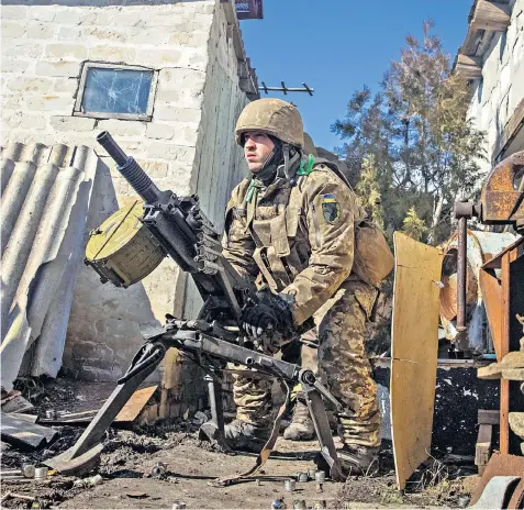  ?? ?? A Ukrainian soldier defending the city of Bakhmut fires an automatic grenade launcher as Russia’s assault in the Donetsk region continues