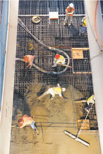  ?? Michael Macor / The Chronicle ?? Workers pour concrete more than 100 feet below the surface to create the platform for the Union Square Station on the Central Subway line, now due to open in late 2019.