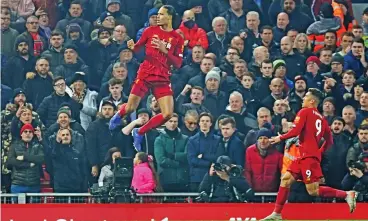  ?? (AFP) ?? Liverpool's Dutch defender Virgil van Dijk (left) celebrates after scoring the opening goal against Manchester United at Anfield, UK, on Sunday