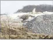  ?? NWA Democrat-Gazette/BEN GOFF • @NWABENGOFF ?? Explosives detonate Wednesday to blast away a section of rock at the constructi­on site.