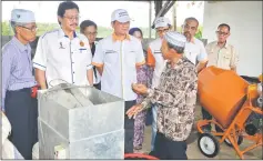  ??  ?? Madius (third left), with Dr Hazland on his right, listens to a briefing by Kampung Bako villager Jaafar Hamzah on how organic waste could be turned into compost.