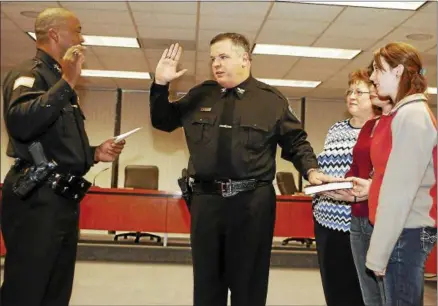  ?? DISPATCH FILE PHOTO ?? In this file photo, John Ball, center with his arm in the air, is sworn in as Madison County Under Sheriff by Sheriff Allen Riley on Wednesday, Dec. 1, 2010in Wampsville. Looking on is Ball’s wife Kelly and two daughters Amanda and Laura.